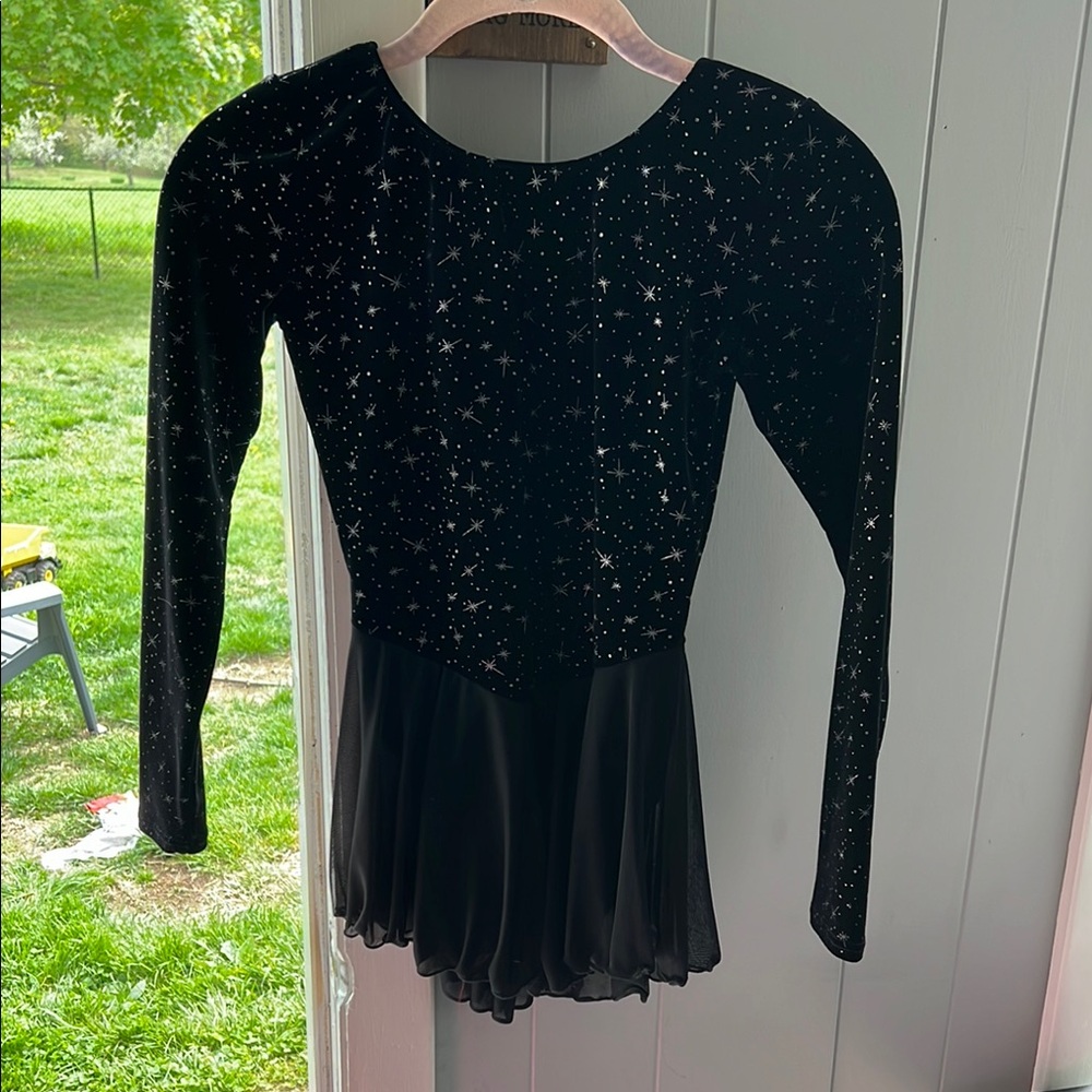 Black velvet figure skating dress with silver star pattern, and flowey skirt.